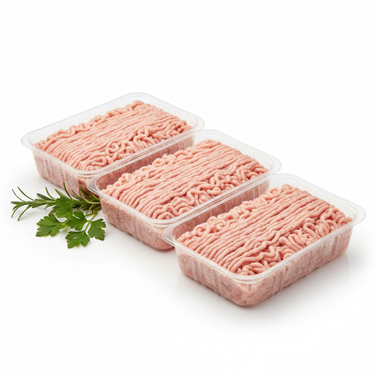 Fresh ground chicken in tray packs, pale pink ground meat neatly arranged